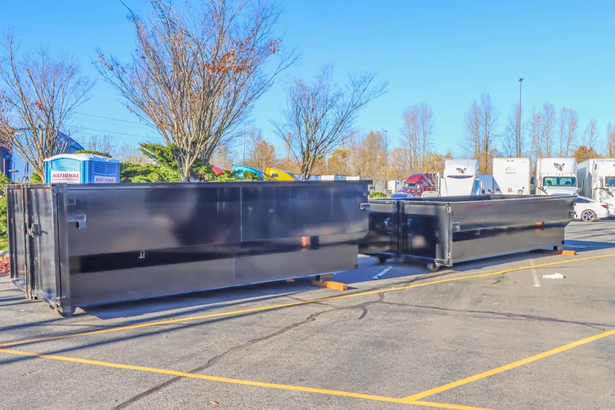 Professional dumpster rental service with roll-off container on residential driveway in New Carlisle